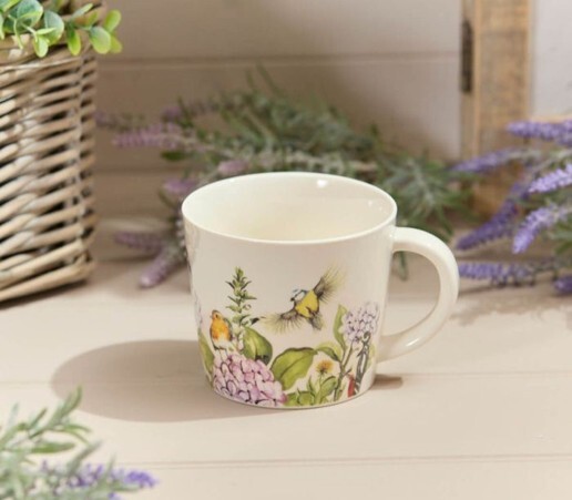 Bird Mugs featuring colourful bird and floral illustrations on a white ceramic mug, styled with lavender and greenery for a nature-inspired gift display.