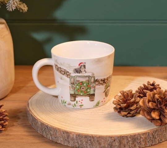 Farm Mugs featuring a festive countryside illustration of a vintage green vehicle and a dog wearing a Santa hat.
