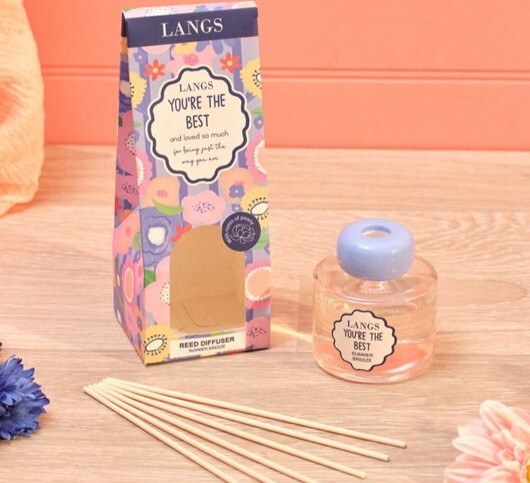 Wholesale Incense gift fragrance product displayed with colourful packaging, a reed diffuser and decorative floral accents. 
